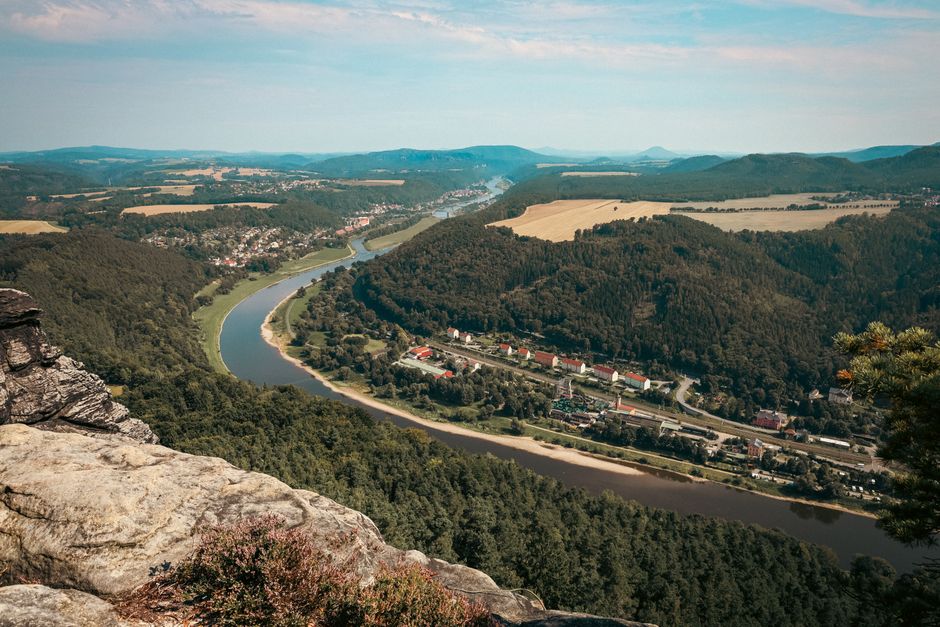 Breathtaking aerial view of the Elbe River winding through the lush landscapes of Bad Schandau, Germany.