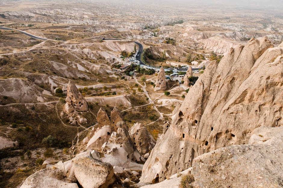 Explore the stunning rocky formations of Cappadocia, Turkey, captured from above with a scenic vista of the arid landscape.