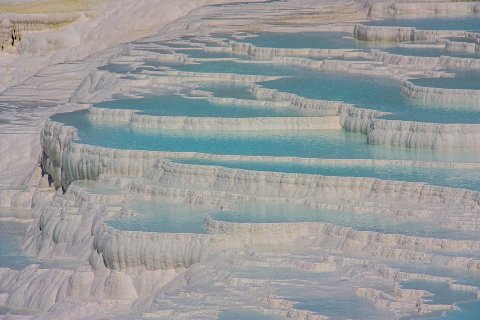 The white travertine terraces of Pamukkale with vibrant blue mineral pools.