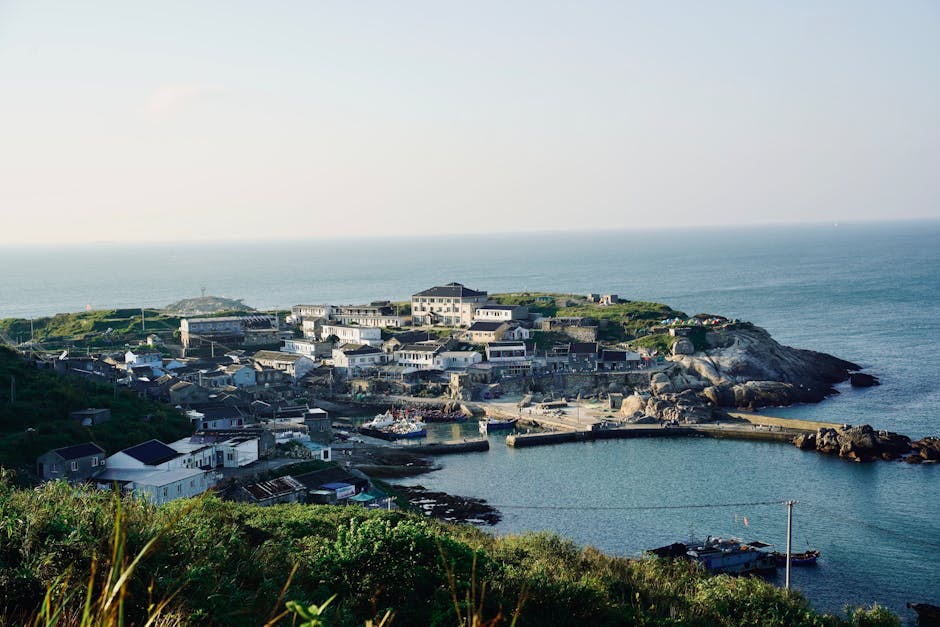 Scenic coastal village with a harbor overlooking the expansive ocean.