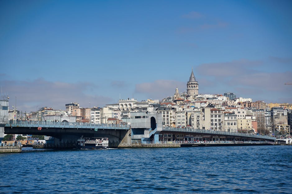View of Galata Tower with the bridge over the Golden Horn, Istanbul during the day.