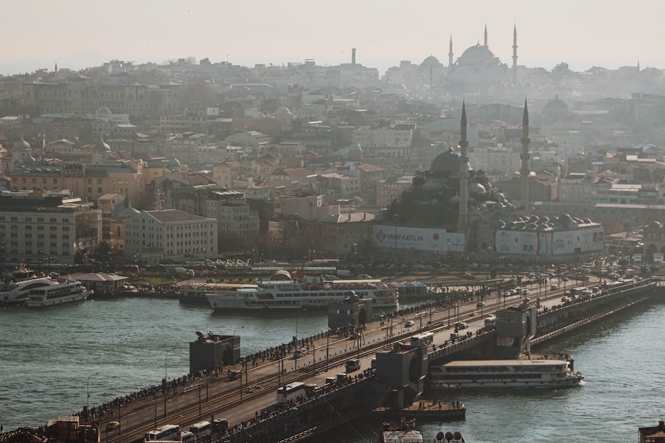 Stunning aerial view of the bustling Galata Bridge connecting city landmarks in Istanbul, Turkey.